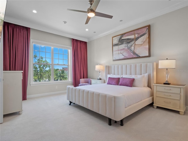 carpeted bedroom with ceiling fan and ornamental molding