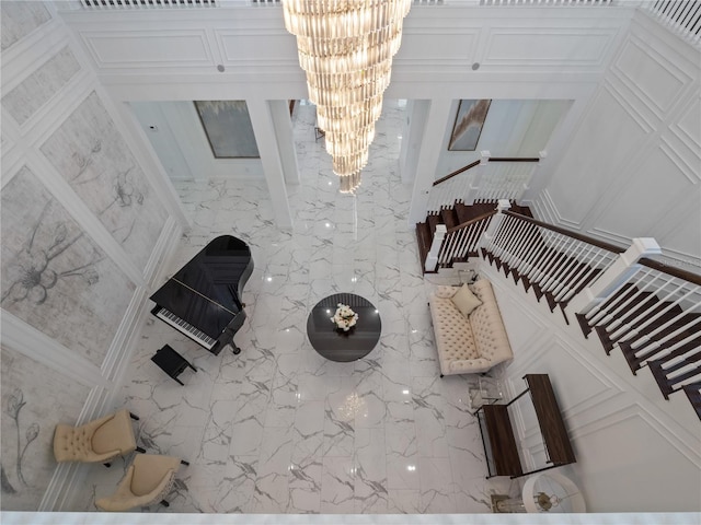 unfurnished living room featuring a notable chandelier