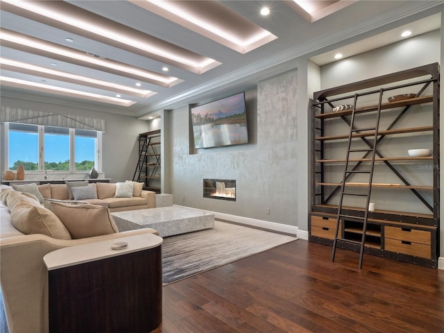 living room with crown molding, a large fireplace, and dark wood-type flooring