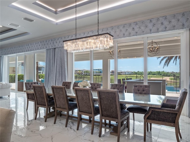 dining space featuring a chandelier, a tray ceiling, and crown molding