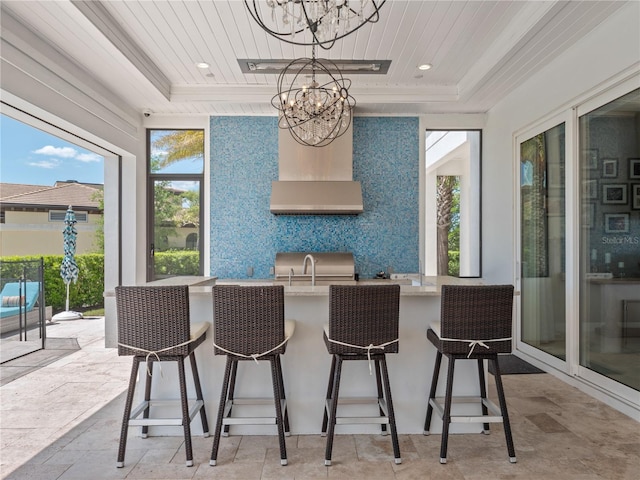 sunroom / solarium featuring a chandelier, a tray ceiling, and wood ceiling