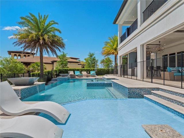 view of pool featuring a patio area, an in ground hot tub, and pool water feature