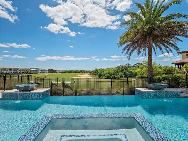 view of swimming pool featuring an in ground hot tub and pool water feature