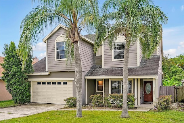 view of front of property featuring a garage and a front lawn