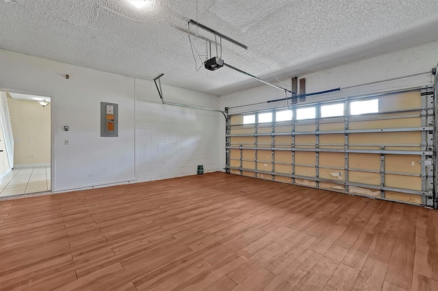 garage featuring electric panel and a garage door opener