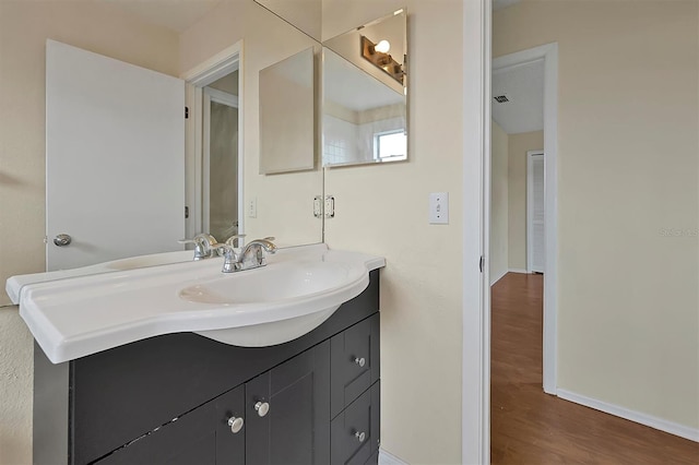 bathroom featuring hardwood / wood-style floors and vanity