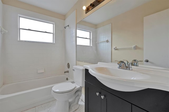 full bathroom featuring toilet, vanity, and tiled shower / bath