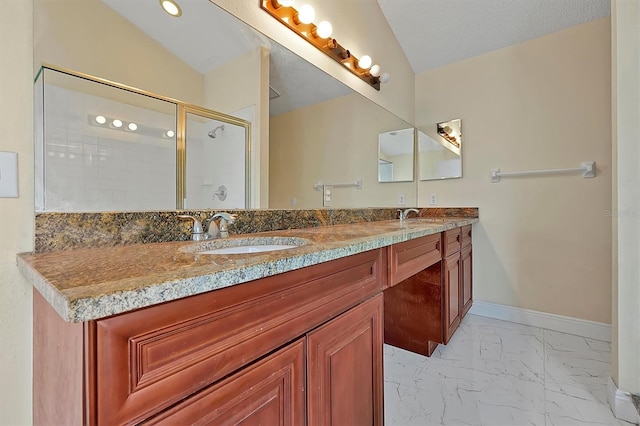 bathroom featuring a textured ceiling, lofted ceiling, vanity, and an enclosed shower