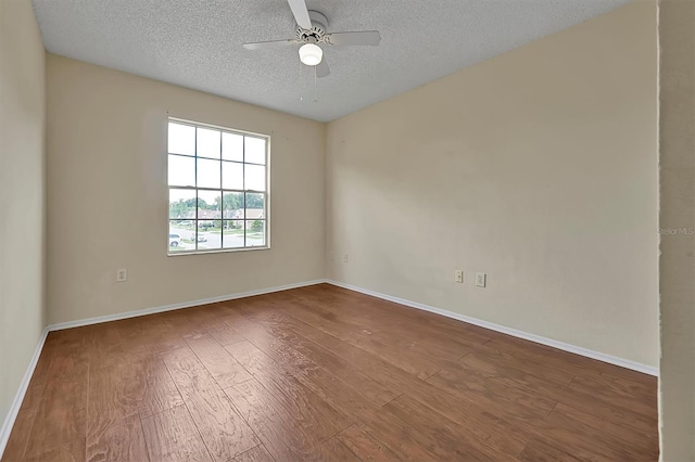 spare room featuring hardwood / wood-style flooring, ceiling fan, and a textured ceiling