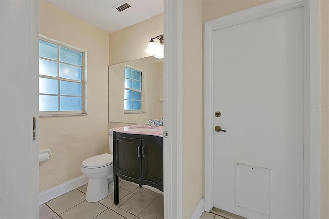 bathroom featuring tile patterned floors, plenty of natural light, vanity, and toilet