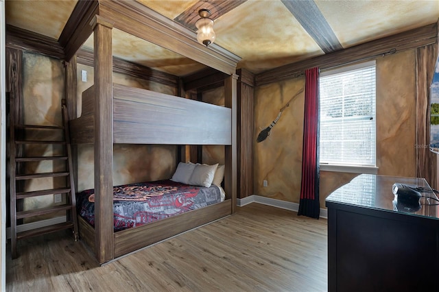 bedroom featuring wood-type flooring and multiple windows