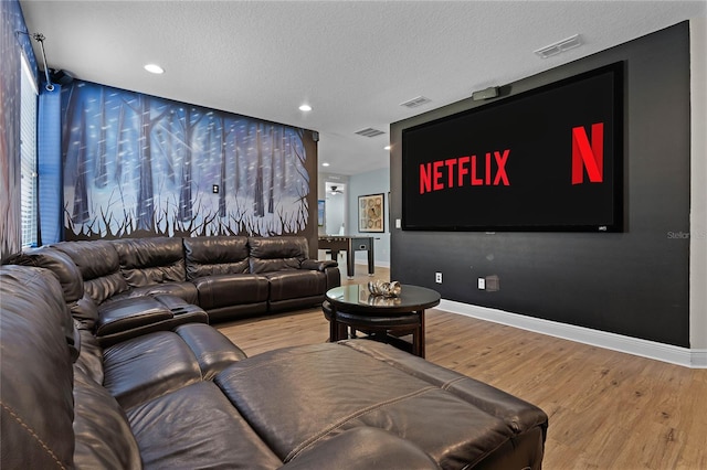 living room with hardwood / wood-style floors and a textured ceiling