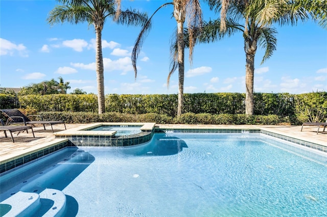 view of pool with an in ground hot tub