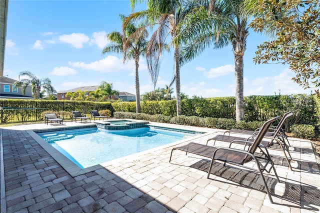 view of pool with an in ground hot tub and a patio