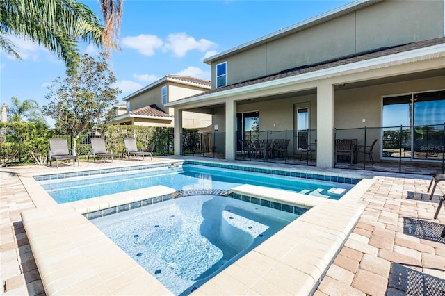 view of pool featuring an in ground hot tub and a patio