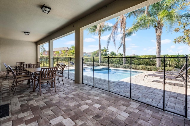 view of pool with a patio area and an in ground hot tub