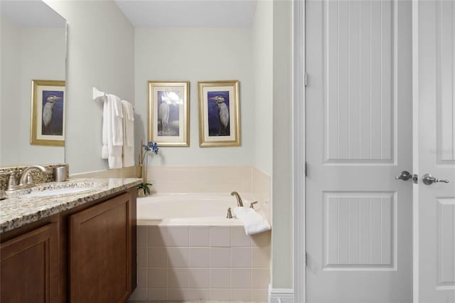 bathroom with vanity and tiled bath