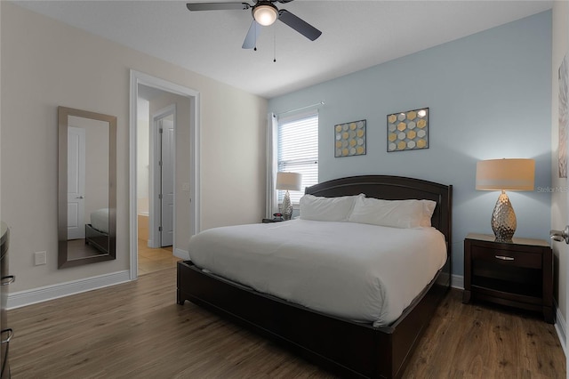 bedroom featuring ceiling fan and dark hardwood / wood-style floors