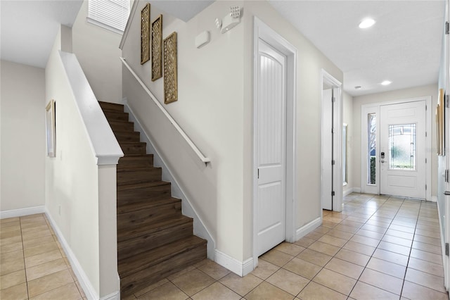 entryway with light tile patterned flooring