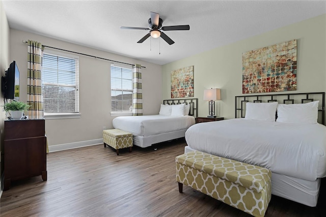 bedroom featuring ceiling fan and dark hardwood / wood-style flooring