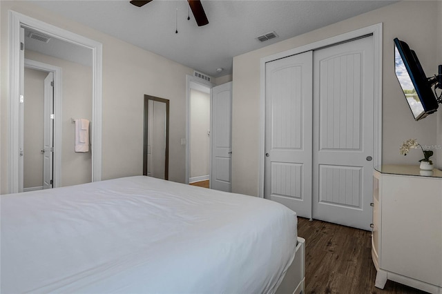 bedroom with a closet, ceiling fan, and dark wood-type flooring