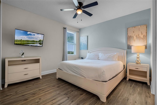 bedroom with ceiling fan and dark hardwood / wood-style flooring