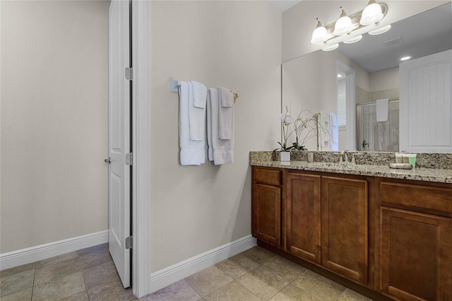 bathroom featuring vanity and a shower with door