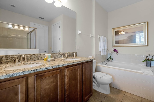 full bathroom with tile patterned flooring, vanity, shower with separate bathtub, and toilet