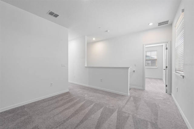 unfurnished room with light carpet