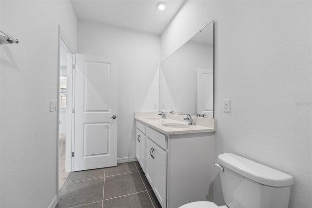 bathroom featuring vanity, toilet, and tile patterned flooring