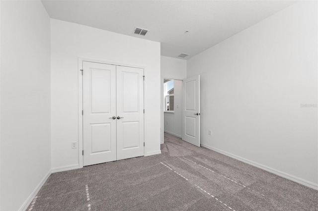 unfurnished bedroom featuring a closet and carpet