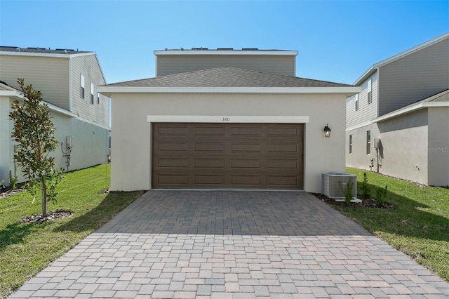 garage with a yard and central air condition unit