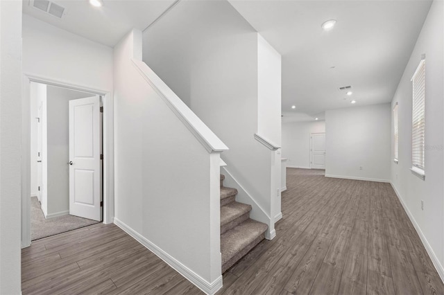 staircase with hardwood / wood-style flooring