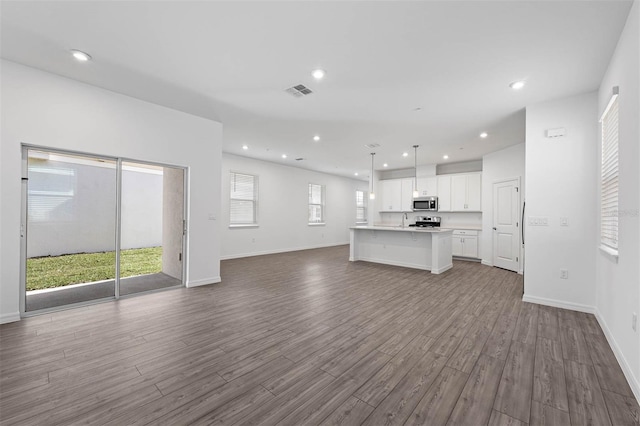 unfurnished living room with wood-type flooring