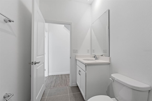 bathroom with vanity, tile patterned floors, and toilet