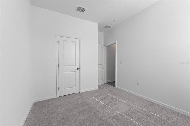 unfurnished bedroom featuring light carpet