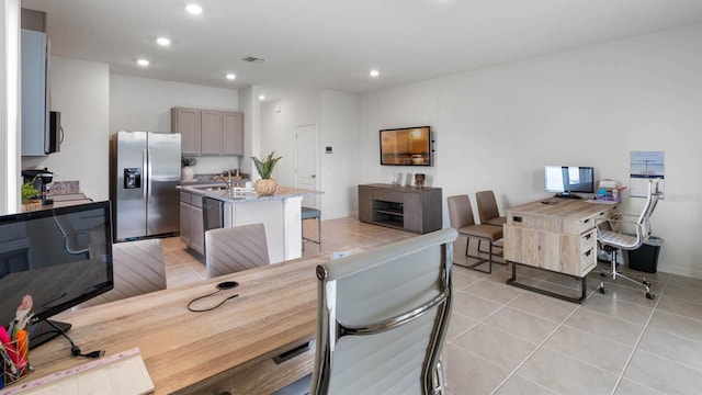 dining area featuring light tile patterned floors and sink