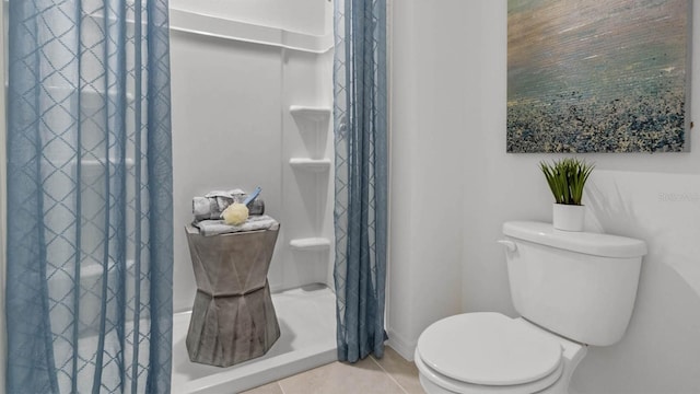 bathroom with walk in shower, tile patterned flooring, and toilet