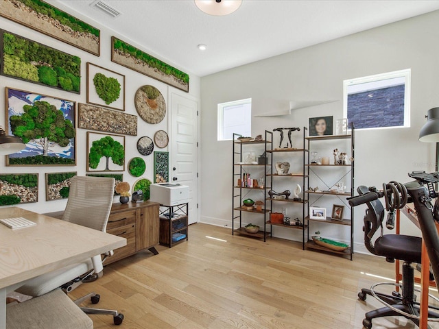 home office with light hardwood / wood-style floors