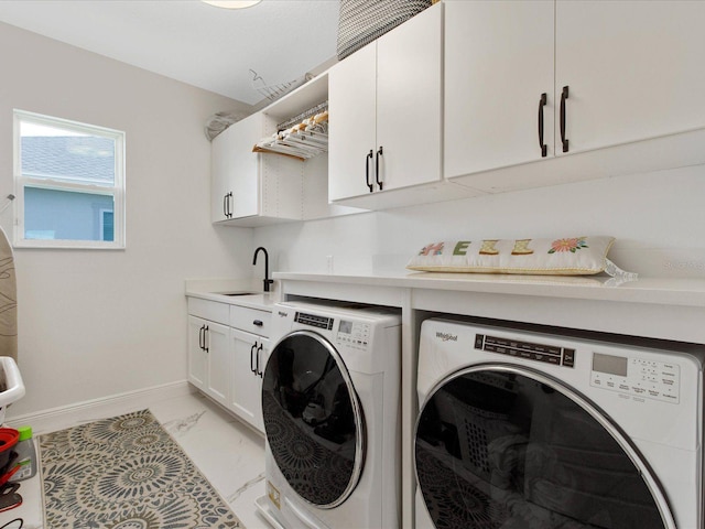 laundry room with cabinets, independent washer and dryer, and sink