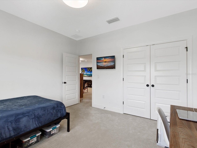 bedroom featuring a closet and light colored carpet