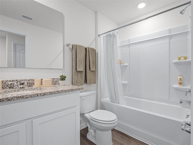 full bathroom featuring shower / tub combo with curtain, vanity, hardwood / wood-style floors, and toilet