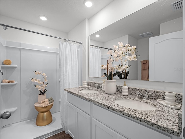 bathroom with vanity and a shower with shower curtain