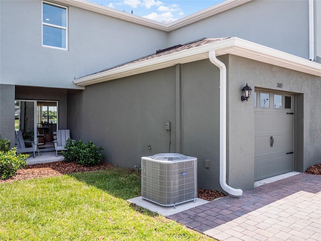 rear view of property featuring a yard and cooling unit