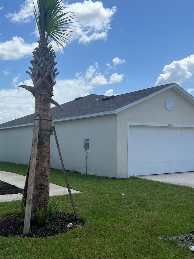 view of side of home with a yard