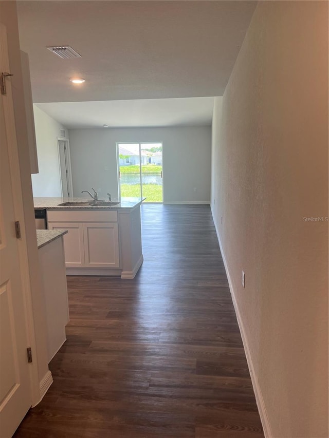 hall with dark hardwood / wood-style floors and sink