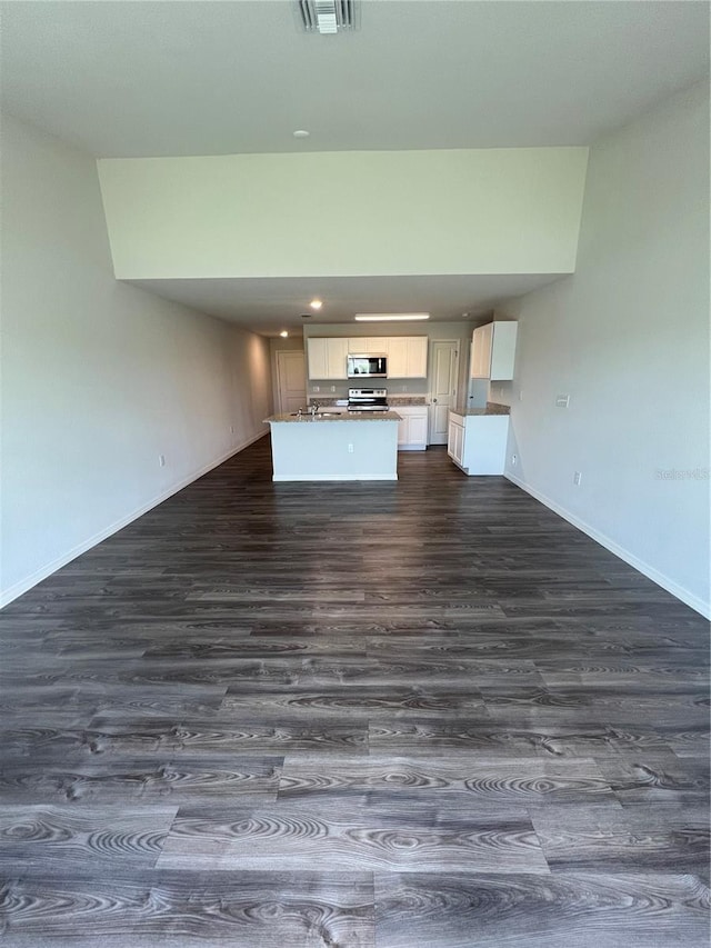 unfurnished living room with dark hardwood / wood-style floors