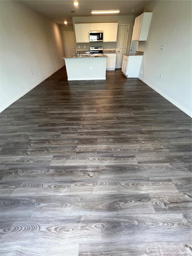 kitchen with dark hardwood / wood-style flooring, white cabinets, and electric range oven