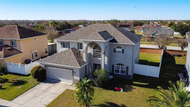 view of front of property featuring a front lawn and a garage