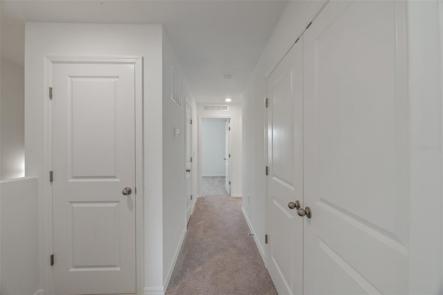 hallway with light colored carpet